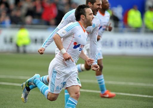 Marseille players celebrate a goal in the match against Lorient on April 27, 2013 in Lorient